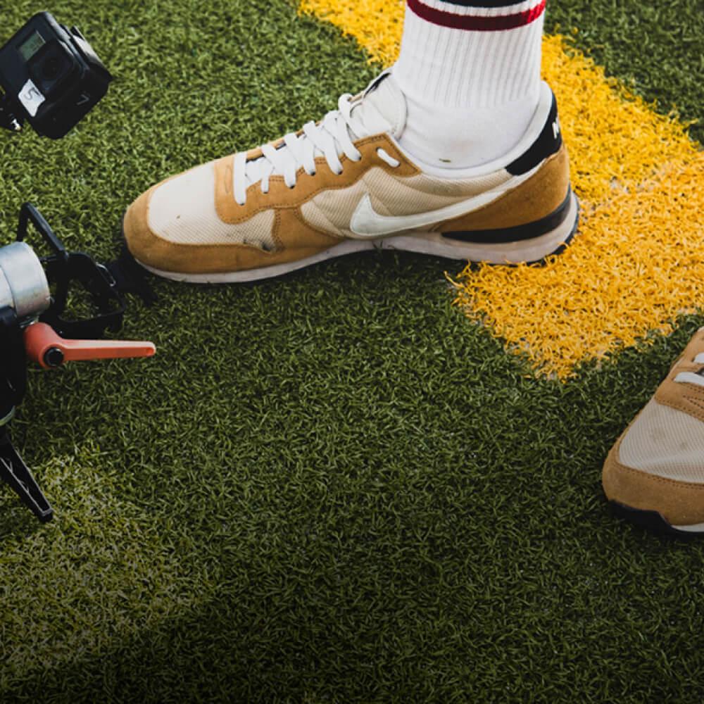 A close-up image showing feet of a football player next to the tracking device.